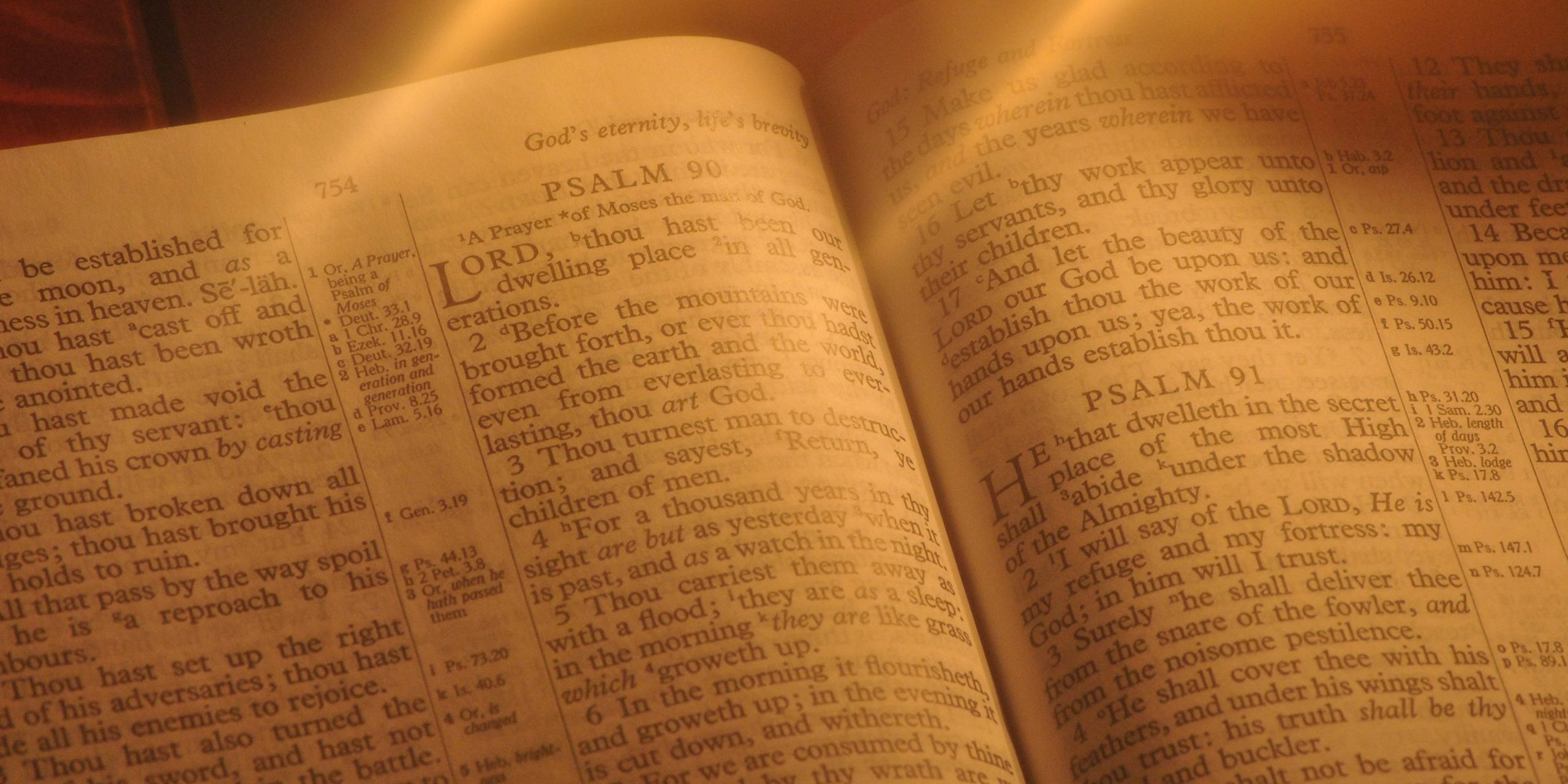 Student studying Holy Bible by Candlelight