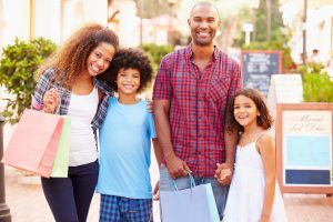 parents shopping and teaching money skills to kids