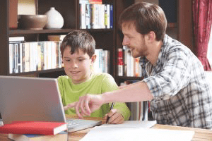 Father tutoring a young boy