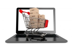 Online Shopping cart on Open Laptop save by comparing items