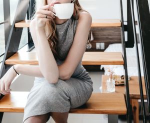 woman sitting on the stairs drinking coffee tea The Kingdom Code Blog 10 Ways to Practice Self-Care