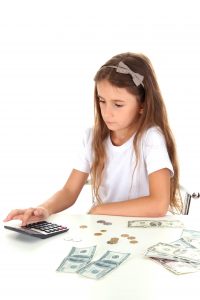 young girl counting money - The Kingdom Code